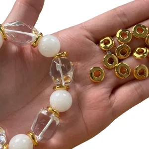 Vacuum plated 18K gold irregular geometric spacer beads bracelet with white and crystal beads.