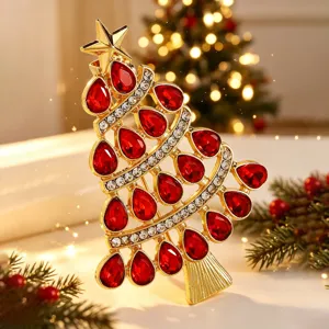 Christmas tree rhinestone brooch pin with red crystal teardrop stones and gold tone finish.