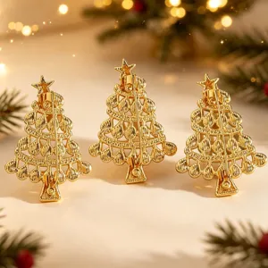 Gold Christmas tree brooch detail view, elegant metal pin for festive winter holiday wear.