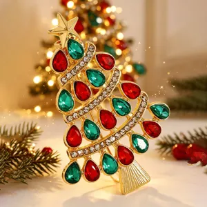 Exquisite gold-tone Christmas tree brooch decorated with red and green rhinestone crystals.