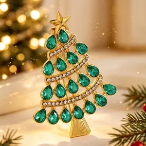 Exquisite Christmas tree brooch with green teardrop crystals and gold tone metal finish.