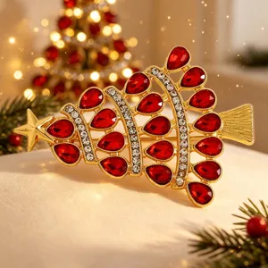 Christmas tree brooch pin with red teardrop rhinestones and gold tone for holiday party decor.