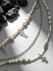 Gedetailleerde close-up van multi-layer parel metaal kruis broekketting accessoire.