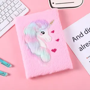 Detailed shot of cute pink plush unicorn notebook with rainbow mane and embroidery design.