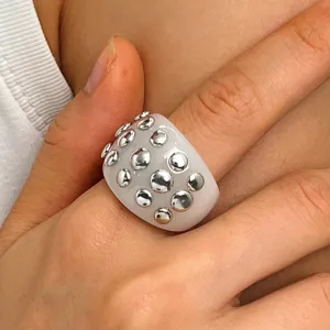 Chunky resin statement ring featuring embedded silver tone metal studs punk style detail shot
