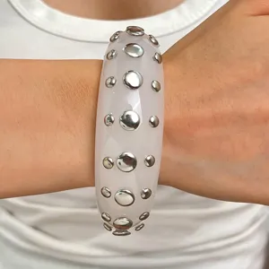 Punk style wide resin cuff bracelet with double row metal dome studs fashion jewelry accessory.