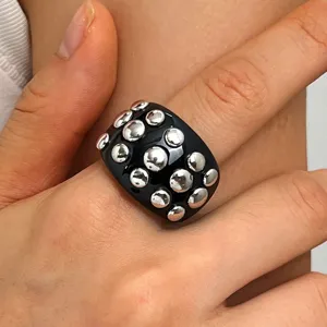 Detailed close-up shot of the trendy punk style black resin ring featuring embedded silver studs.