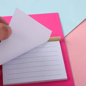 Close-up detail of portable tearable lined sticky notepad with wooden pen holder design.