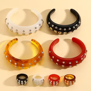 Detailed view showcasing the punk style resin rivet bangles and matching rings set.