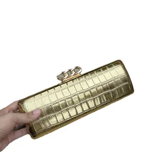 Gold crocodile pattern metallic clutch bag with chain lock, elegant evening purse for women.