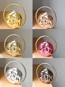 Metallic camellia flower relief round handbag detail view, elegant gold silver round handle clutch