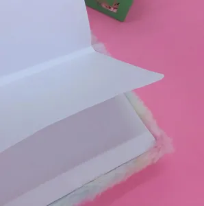 Close-up detail of fuzzy rainbow notebook, showing soft plush cover and clean white pages.