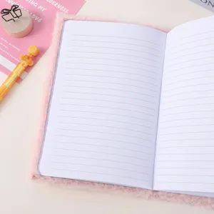 Pink fluffy notebook with lined pages, soft plush cover journal for students and daily planning.