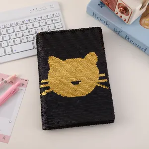 Reversible sequin notebook with cute cat face design, sparkle diary journal for daily notes.