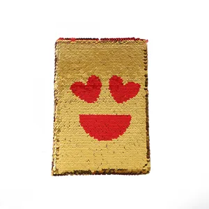 Shiny reversible sequin notebook with heart eyes emoji design, perfect for daily journaling.