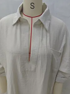 Detailed view of women's solid color casual loose blouse with exquisite embroidery placket.