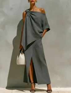 Detail shot of asymmetric one-shoulder top and front split maxi skirt set in dark grey.
