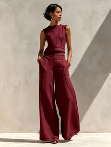 Detail shot of the maroon sleeveless top and wide leg pants set with contrast black stitching.