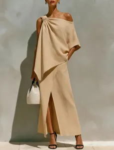 Detail view of the elegant one-shoulder top and high slit skirt set in solid beige color.