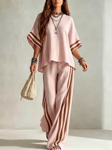 Detail view of the elegant pink linen two piece resort wear set with stylish brown side stripes.