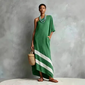 Detail view of a green one-shoulder maxi dress with white diagonal stripes, cotton linen.