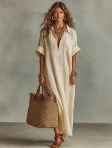Detail view of model wearing loose beige short sleeve dress with straw bag and chic accessories.