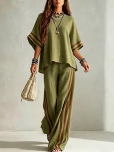 Casual two-piece resort set for women, loose linen-like short sleeve top and striped pants.