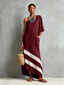 Detail view of a stylish one-shoulder linen long dress featuring striking diagonal color block stripes.