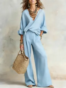 Light blue loose vacation two-piece outfit detail, elegant V-neck and wide leg pants style.