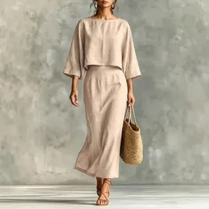 Detail view of casual beige linen two-piece outfit featuring a loose top and high waist skirt.