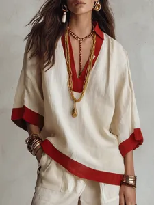 Dettaglio del set da donna per autunno con top a mezze maniche e pantaloni ampi bicolore.