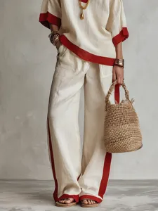 Vista dettagliata dell'elegante completo da donna in due pezzi con top e pantaloni ampi.