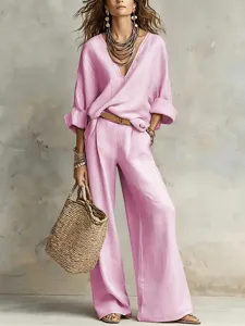 Pink loose casual V-neck blouse and wide-leg trousers set, stylish resort wear detail.