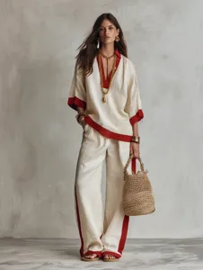 Completo autunnale chic con scollo a V, mezze maniche e pantaloni larghi con dettagli a contrasto.