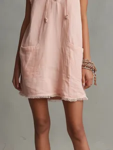 Pink sleeveless mini dress featuring front utility pockets and frayed hem, minimalist detail view.
