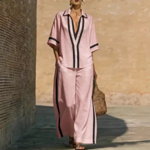 Women's pink casual two piece set short sleeve shirt and wide leg pants with black piping.