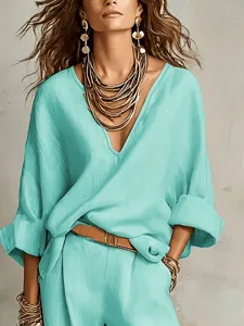 Casual loose resort outfit for women featuring a chic V-neck top and matching trousers set.