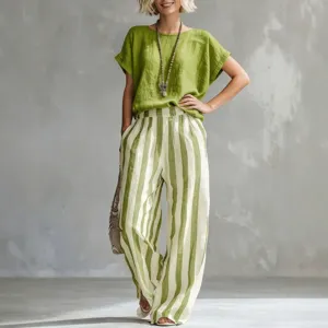 Casual women summer outfit featuring green round neck top and trendy striped wide-leg pants.