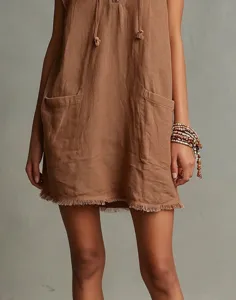 Women sleeveless mini dress detail, raw hem patch pocket design for minimalist fashion style.
