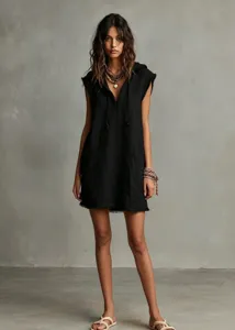 Sleeveless hooded mini dress detail view, black raw edge design with convenient pockets.