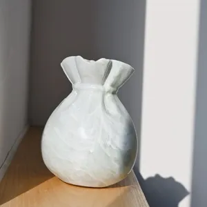 Exquisite lucky bag shaped ceramic vase detail, unique pleated opening, elegant home decor accent.
