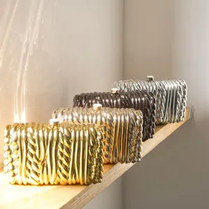 Twisted metallic hard box clutch bag, elegant minimalist evening purse for women and parties.