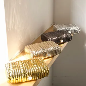 Exquisite metallic twisted texture hard box clutch bag with minimalist design for evening events.