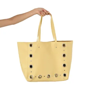 Yellow leather tote bag with stylish metal eyelets and double straps for daily casual wear.