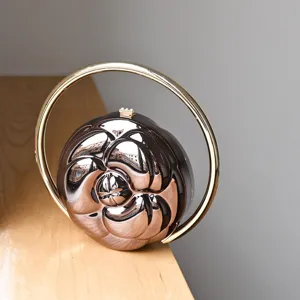 Camellia embossed round ball handbag with gilded circular handle, elegant acrylic clutch bag.