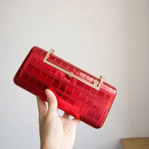 Stunning red evening clutch detail, glossy crocodile texture with sparkly rhinestone metal clasp.