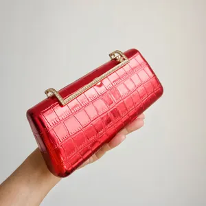 Red metallic evening clutch bag with rhinestone handle, elegant design for party and wedding events.