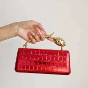 Detailansicht der roten metallischen Krokodilmuster Abendtasche mit goldenem Tulpenhenkel.