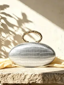 French luxury silver oval clutch bag with crocodile texture and gold metal ring handle.