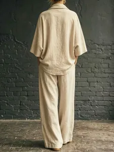 Casual linen two-piece set featuring a loose cowl neck top and wide leg trousers in beige.